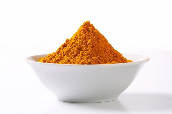Turmeric Powder on a white bowl with white background